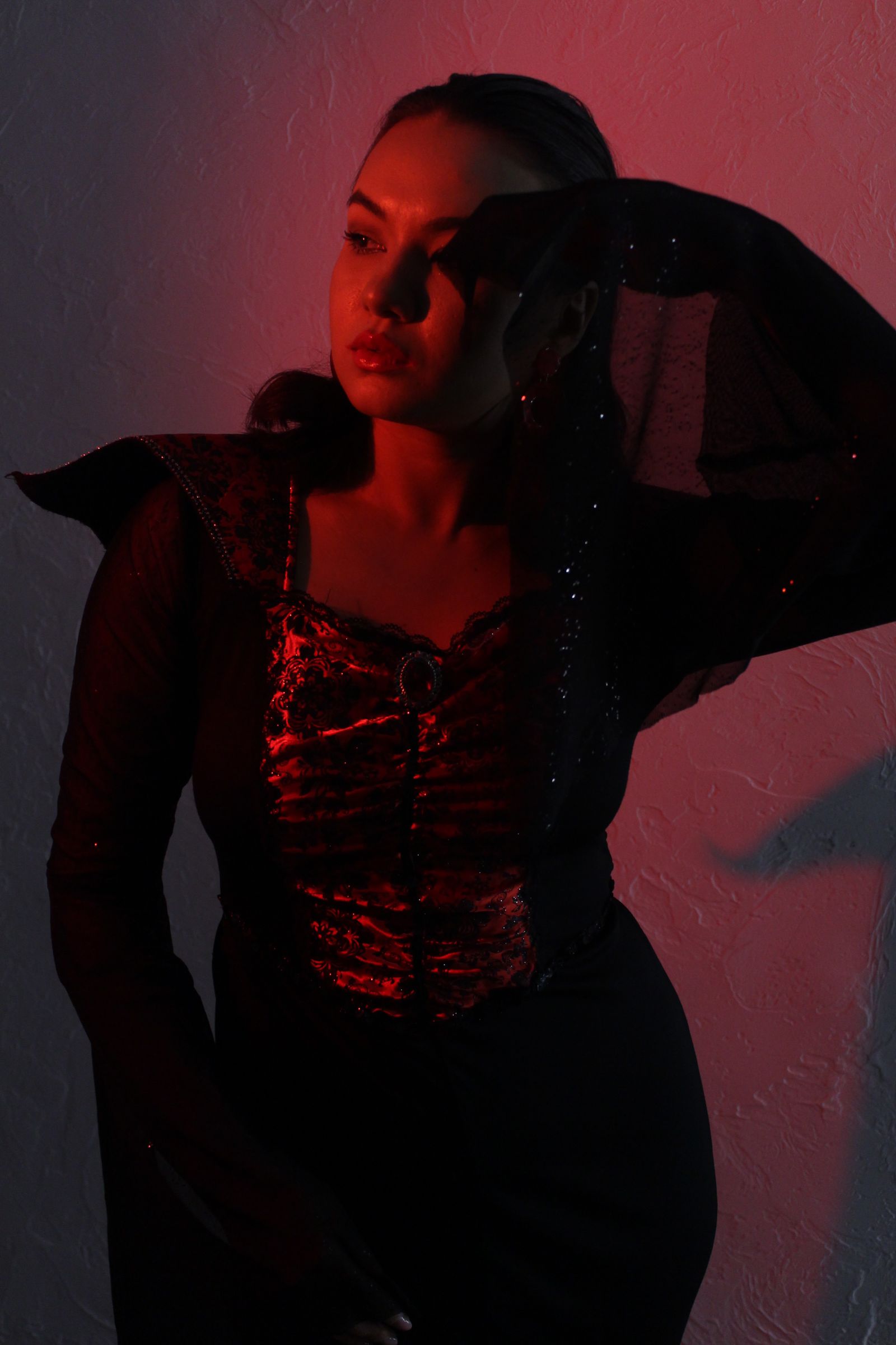 Real Pexels portrait of a founder in a black studio with red shadow light