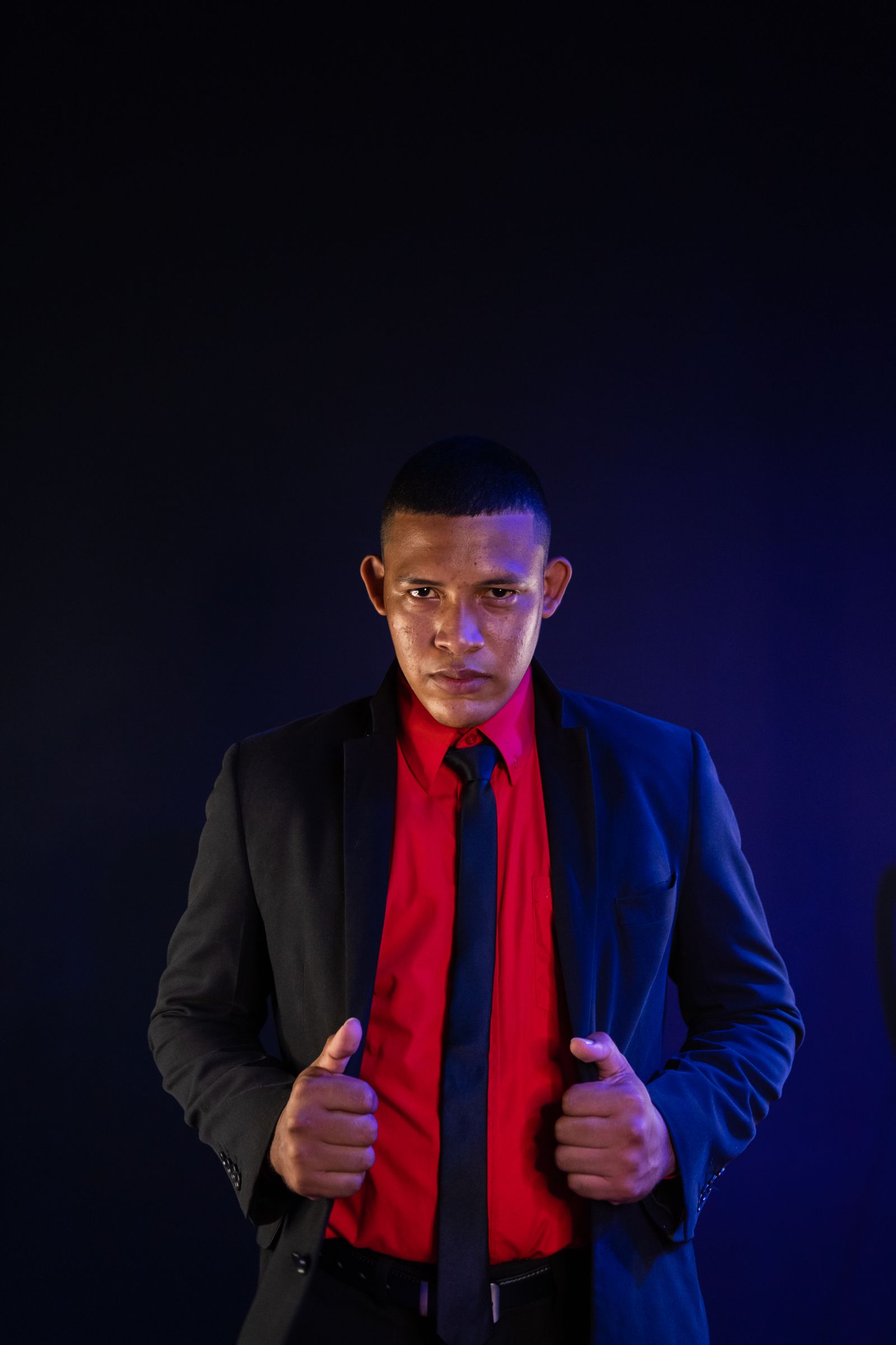 Real Pexels portrait of a professional in a dark suit with red light