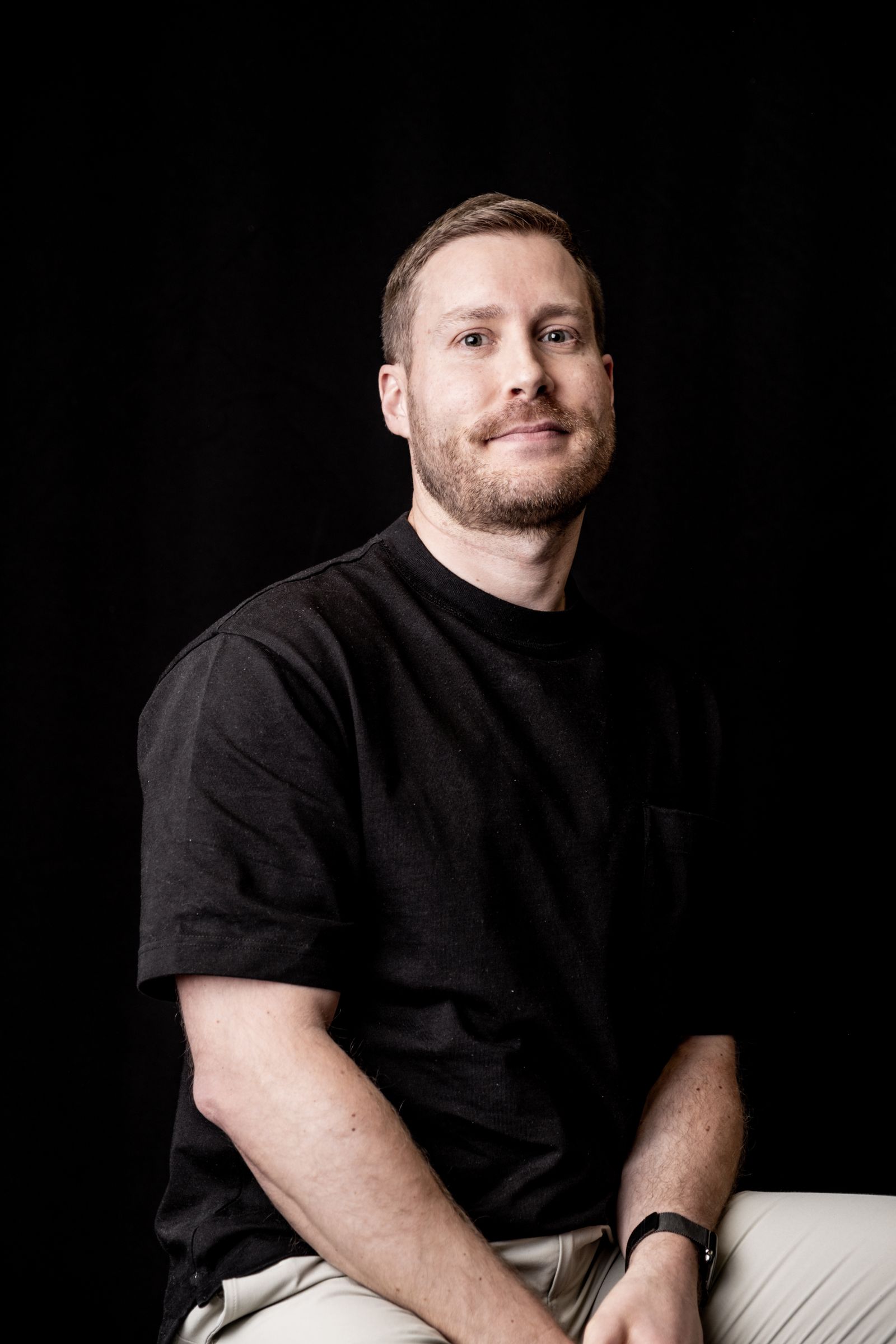 Pexels portrait of a professional seated against a black background