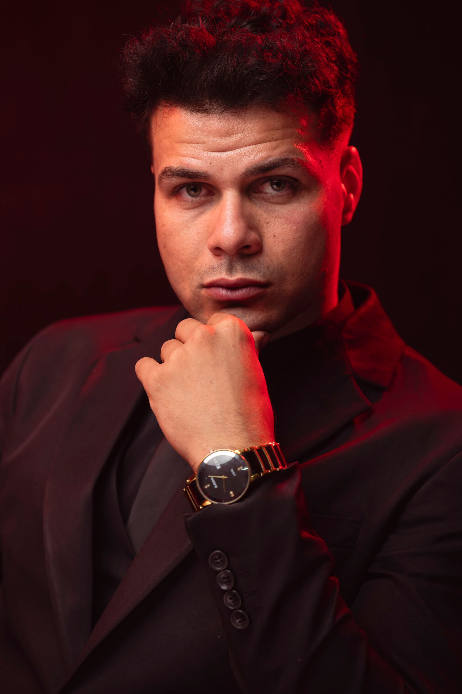 Real Pexels portrait of a professional in a black suit under cinematic red light